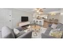 Open-concept living area with modern furnishings, a breakfast bar, and seamless flow to the kitchen at 415 Parkdale Dr # 2B, Charleston, SC 29414
