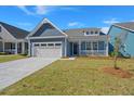 Charming blue home with a two-car garage and inviting front porch at 4996 Song Sparrow Way, Summerville, SC 29483