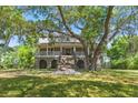 Charming two-story home with a welcoming front porch and well-maintained lawn and mature trees at 5569 Frisco Ln, Johns Island, SC 29455