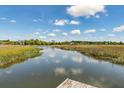 Scenic view of a tranquil river, showcasing the natural beauty of the surrounding landscape at 5569 Frisco Ln, Johns Island, SC 29455