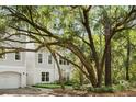 Charming three-story home with light gray siding, surrounded by mature trees and greenery, creating a peaceful curb appeal at 60 Fenwick Hall Allee # 321, Johns Island, SC 29455