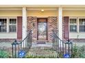 Close-up of the front door featuring a decorative glass panel and brick facade at 7 Andrea Ct, Hanahan, SC 29410