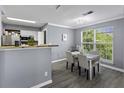 Cozy dining area with table, chairs, and natural light from the large window at 700 Daniel Ellis Dr # 10307, Charleston, SC 29412