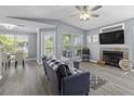 Bright living room with fireplace, modern furniture, and open view to the dining area at 700 Daniel Ellis Dr # 10307, Charleston, SC 29412