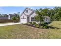 Beautifully landscaped front yard and garage with concrete driveway at 707 Butter Rd, Bonneau, SC 29431
