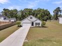 An aerial view showing the home's front lawn, driveway, and surrounding greenery at 707 Butter Rd, Bonneau, SC 29431