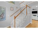 Elegant staircase with carpeted steps, white railings, and natural wood accents leads to the second floor at 715 Majestic Oak Dr, Charleston, SC 29412