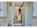 Inviting entryway features an open door, views of staircase, and stone accents at 853 Bibury Ct, Charleston, SC 29414