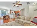 Bright open-concept living room with hardwood floors flowing into the dining and kitchen at 853 Bibury Ct, Charleston, SC 29414