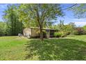 Charming home with screened porch and lush surroundings. Mature trees provide shade in the backyard at 1019 Levi Lake Rd, Johns Island, SC 29455