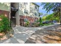 Exterior view of a condo building showing the walkway and colorful landscaping surrounding the property at 1025 Riverland Woods Pl # 1008, Charleston, SC 29412