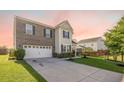 View of home featuring brick and siding facade, well-kept landscaping and spacious concrete driveway at 103 Radtko Rd, Summerville, SC 29486
