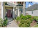 Inviting front entry with a beautiful garden, providing a warm welcome to this charming home at 1034 Sterling Ln, Summerville, SC 29483