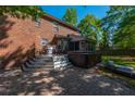View of the brick patio featuring a hot tub, grill, and outdoor seating in the fenced backyard at 105 Birkbeck Ct, Goose Creek, SC 29445