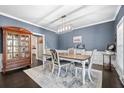 Dining room with blue walls, a decorative rug, stylish lighting, and classic furniture, creating an elegant space at 105 Birkbeck Ct, Goose Creek, SC 29445