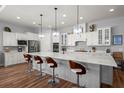 Modern kitchen features a large island, stainless steel appliances, and custom white cabinetry at 108 Bluff Isle Ct, Summerville, SC 29486