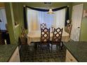 Charming dining area with patterned flooring, a traditional table, and blue accents, bathed in natural light at 113 Saxton Ct, Goose Creek, SC 29445