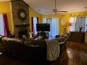 Inviting living room with a striking brick fireplace, a large TV, and comfortable leather seating at 113 Saxton Ct, Goose Creek, SC 29445