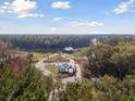 Aerial view showcasing the community entrance amidst a serene forest setting at 1149 Darling St, Summerville, SC 29485