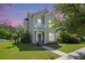 Charming two-story home featuring a quaint balcony, manicured lawn, and inviting front entrance at 117 Blue Bonnet St, Summerville, SC 29483