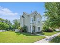 Charming two-story home featuring a quaint balcony, manicured lawn, and inviting front entrance at 117 Blue Bonnet St, Summerville, SC 29483