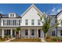 Inviting two-story home with a covered front porch and meticulously maintained landscaping at 119 Summer Tanager Dr, Ravenel, SC 29470