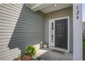Inviting front door with sidelights and a small garden area at 124 Sumac Dr, Goose Creek, SC 29445