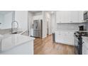 Bright kitchen featuring stainless steel appliances and white cabinets at 124 Sumac Dr, Goose Creek, SC 29445