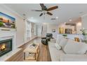 Bright living room with a fireplace, ceiling fan, and hardwood floors, blending comfort and style at 1426 Tannery Row, Johns Island, SC 29455