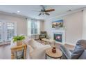 Cozy living room featuring a fireplace, hardwood floors, and comfortable seating, perfect for relaxation at 1426 Tannery Row, Johns Island, SC 29455