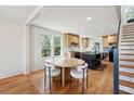 Well-lit kitchen with an island, stainless steel appliances, and an adjacent breakfast nook with hardwood floors at 1456 Remount Rd, North Charleston, SC 29406