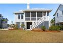 The rear exterior features a screened porch, stairs, and a well-maintained lawn at 1604 Bernier Commons, Johns Island, SC 29455