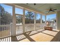 A screened porch has outdoor seating, ceiling fans, and views of the surrounding landscape at 1604 Bernier Commons, Johns Island, SC 29455