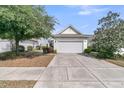 The home features a clean two car garage and neutral paint, complemented by mature trees at 170 Sea Lavender Ln, Summerville, SC 29486