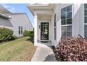 Inviting front entryway with a black door and glass window, framed by white columns and lush landscaping at 170 Sea Lavender Ln, Summerville, SC 29486