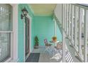 Inviting balcony features seating, plants, and light-blue siding at 172 Saint Philip St # F, Charleston, SC 29403