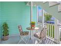 A cozy balcony seating area with flowers at 172 Saint Philip St # F, Charleston, SC 29403