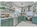 Modern kitchen showcasing granite countertops, stainless steel appliances, and stylish green cabinets at 203 Two Hitch Rd, Goose Creek, SC 29445