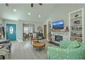 Inviting living room with a stone fireplace, built-in bookshelves, and a teal front door at 203 Two Hitch Rd, Goose Creek, SC 29445