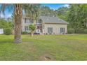 Two-story home with a well-manicured lawn and mature trees at 2275 Pristine View Rd, Charleston, SC 29414