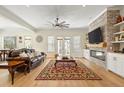 Spacious living room with a brick fireplace, hardwood floors, and large windows for natural light at 2408 Bending Oak Loop, Mount Pleasant, SC 29466