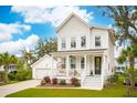 Charming two-story home with white siding, a inviting front porch and a detached garage at 2815 Colonel Harrison Dr, Johns Island, SC 29455