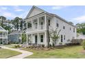 Corner-lot home featuring a double-decker porch and green surroundings at 2866 Sugarberry Ln, Johns Island, SC 29455