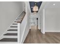 Bright foyer with hardwood floors, staircase, and decorative ceiling at 2866 Sugarberry Ln, Johns Island, SC 29455