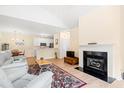 Open living room and kitchen area featuring fireplace and dining table at 308 Pickering Ln, Charleston, SC 29414