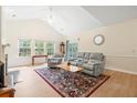 Bright living room with vaulted ceiling, light floors, fireplace, and lots of natural light at 308 Pickering Ln, Charleston, SC 29414