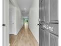 Inviting hallway with wood flooring, leading to bright and airy living spaces at 313 Squire Pope Rd, Summerville, SC 29486