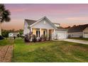 Inviting single-Gathering home with a lush green lawn, an attached garage and front porch at 3431 Great Egret Dr, Johns Island, SC 29455