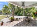 Charming front porch with brick flooring, palm trees, and ample space for outdoor seating, perfect for enjoying the outdoors at 356 Hobcaw Dr, Mount Pleasant, SC 29464