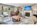 Cozy living room features a brick fireplace, built-in shelving, and comfortable seating, creating a warm and inviting space at 356 Hobcaw Dr, Mount Pleasant, SC 29464